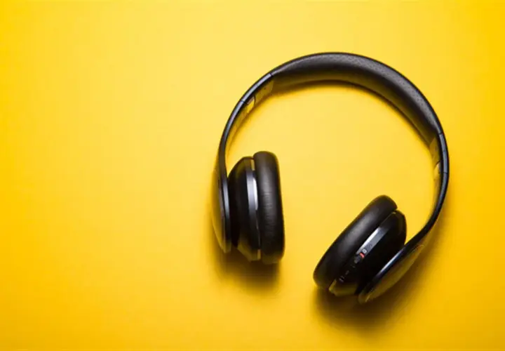 Casque audio noir sur fond jaune, parfait pour écouter un livre audio comment ça marche.