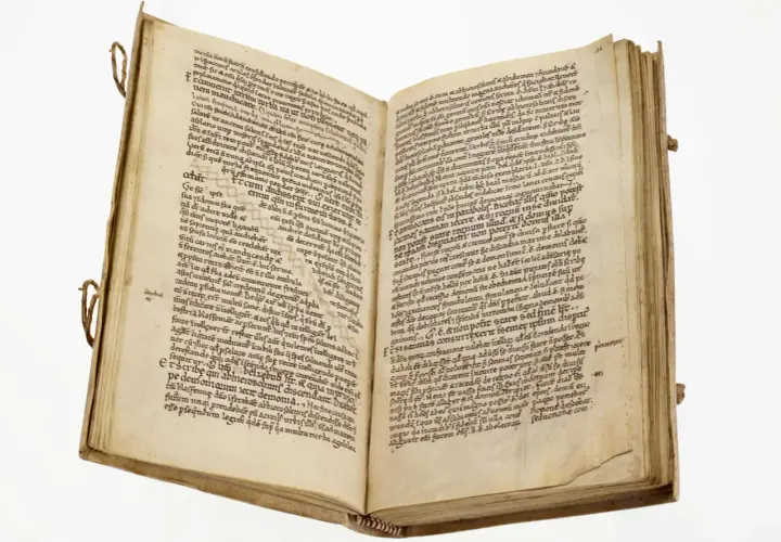 Page de manuscrit ancien avec des lignes de texte manuscrit en latin. Le livre est ouvert, révélant deux pages remplies d'écriture.