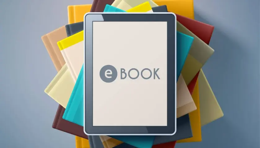 Une tablette affiche "e BOOK" au milieu d'une pile de livres colorés.